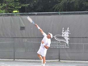 Man Serving on Outdoor Courts