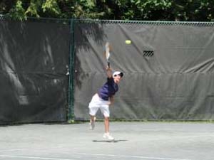 Boy Serving on Outdoor Courts